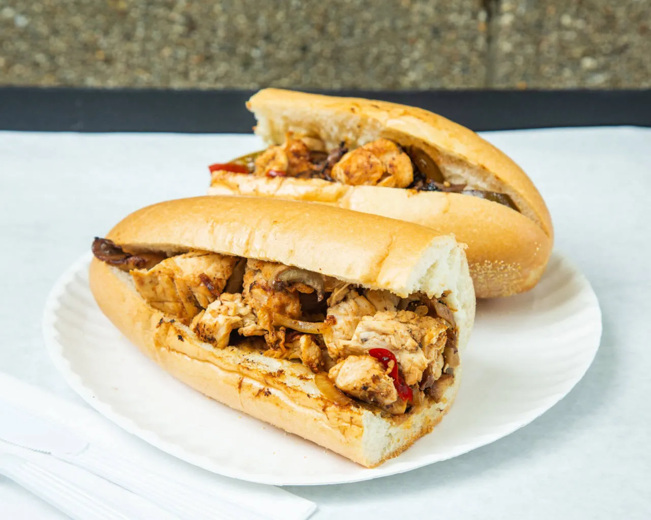 Grilled chicken sub with peppers and onions
